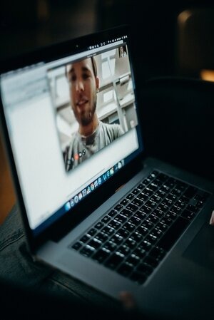 laptop open with video conferencing